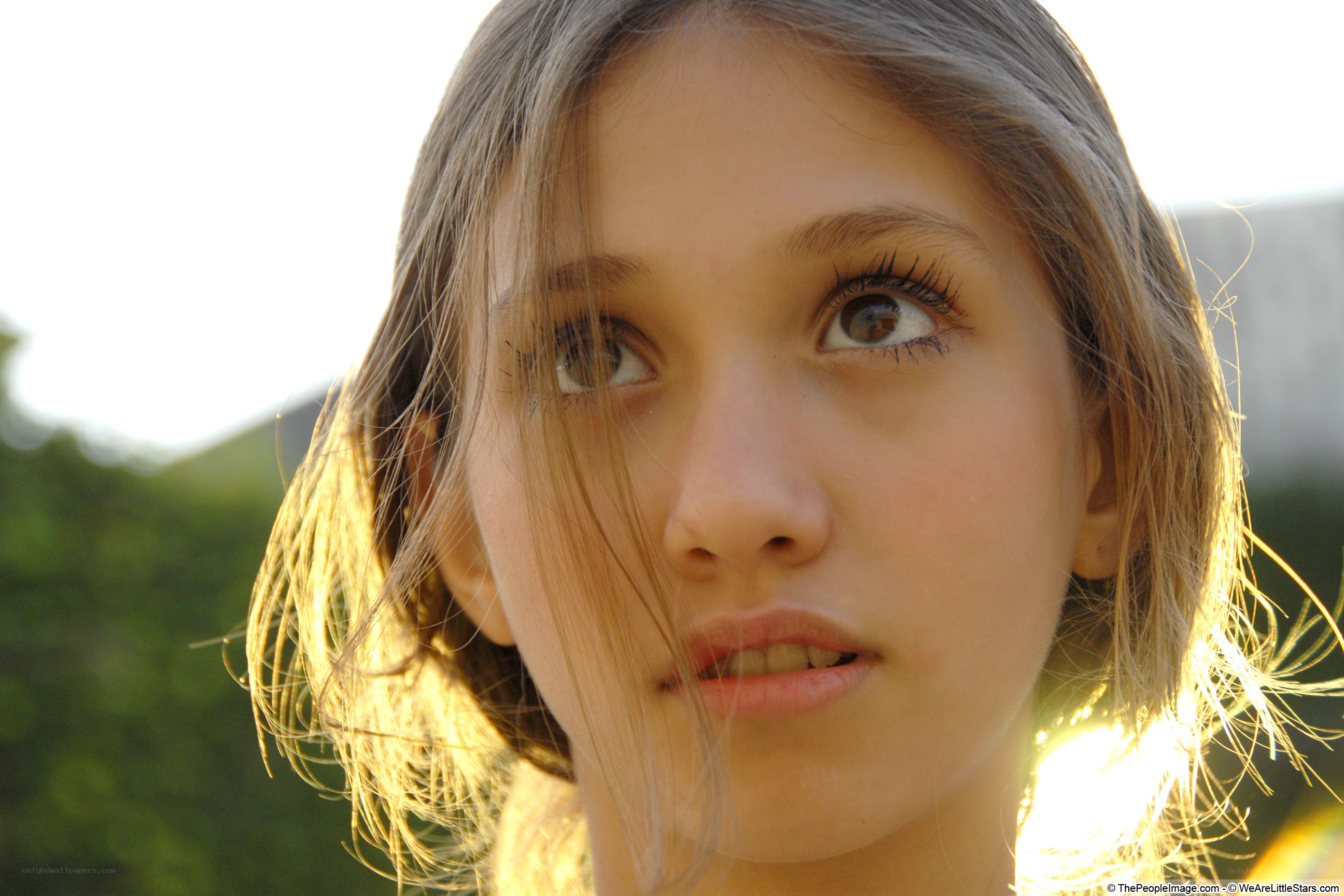 girl looking up at sunset