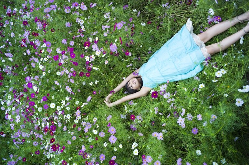 Girl lying in a flower field