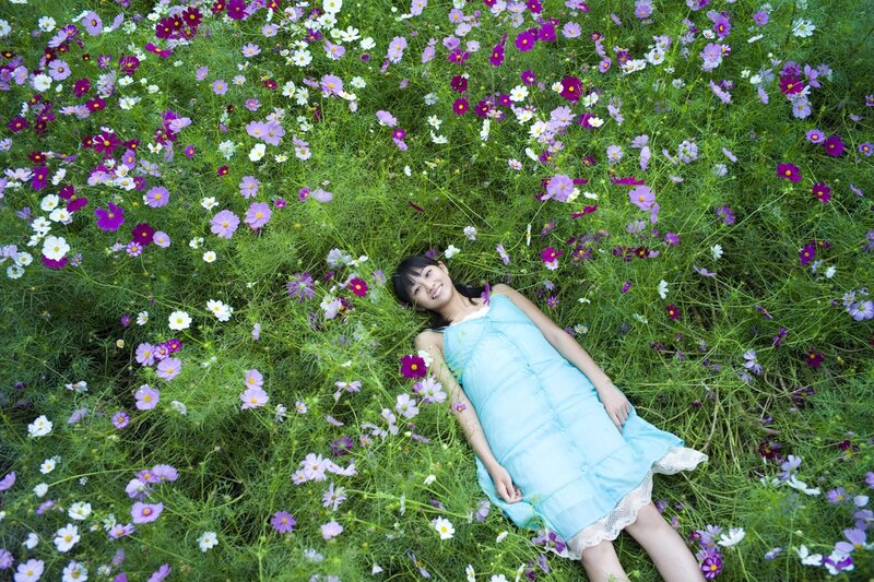 Girl lying in a flower field