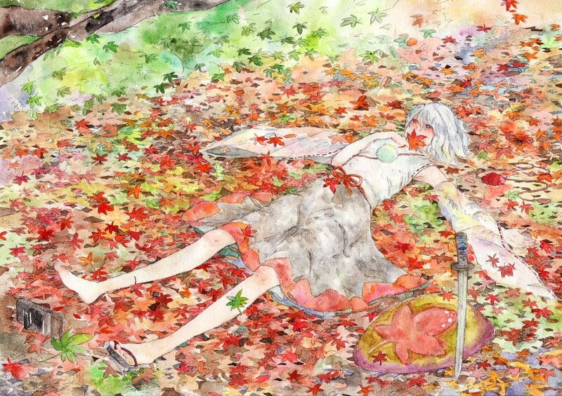 Girl lying in autumn leaves