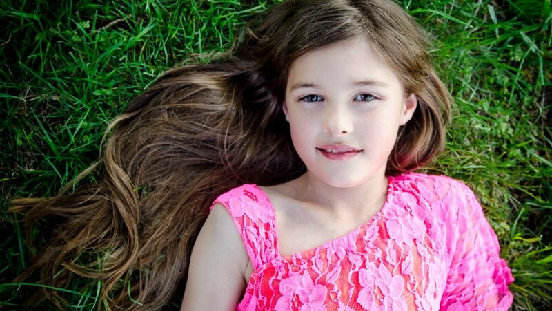 Girl Lying in Grass — Pink, Serene