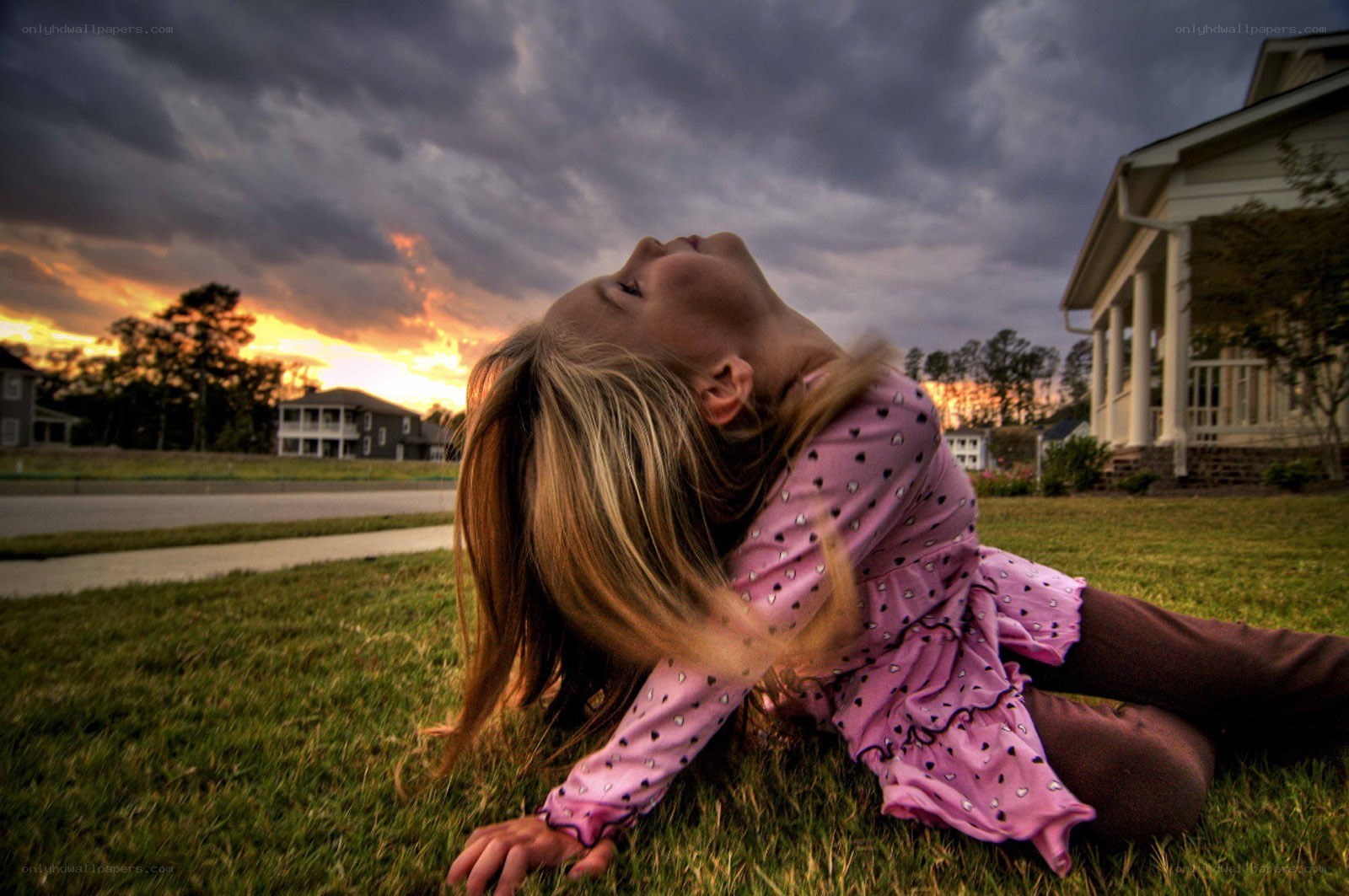 girl lying on grass at sunset