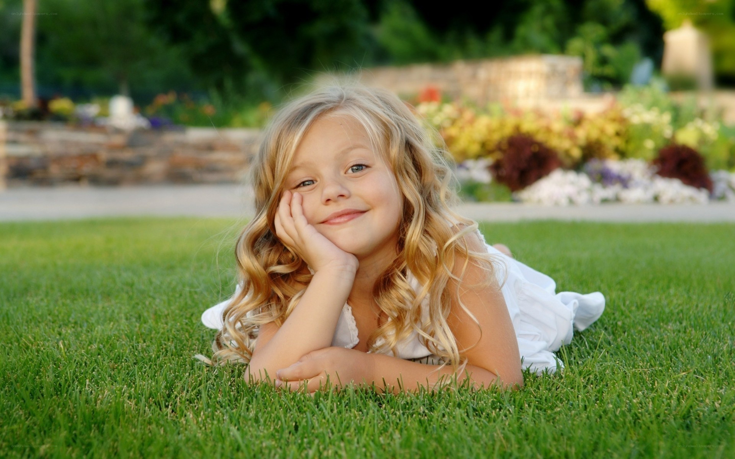 girl lying on grass smiling