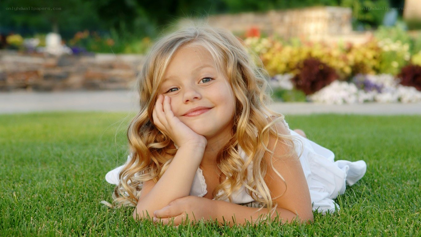 girl lying on grass smiling