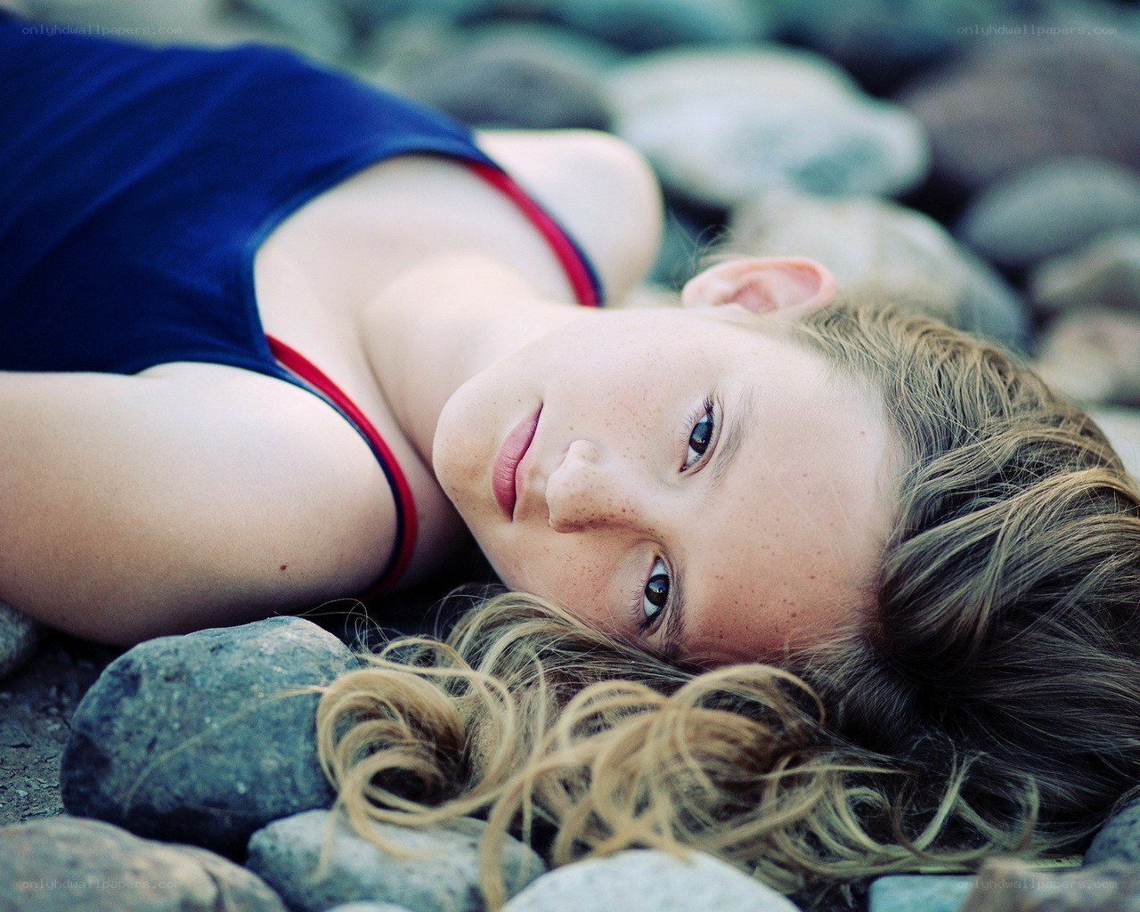 girl lying on rocks