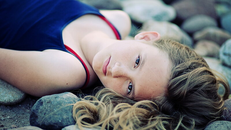 Girl Lying on Rocks — Blue
