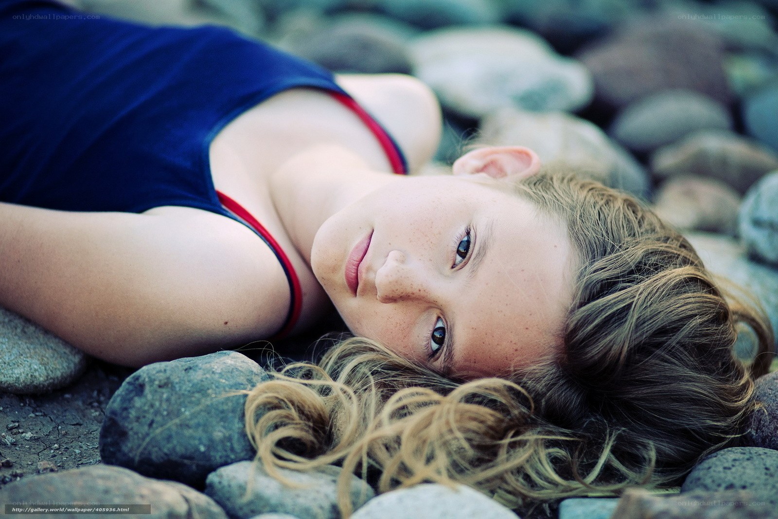 girl lying on rocks