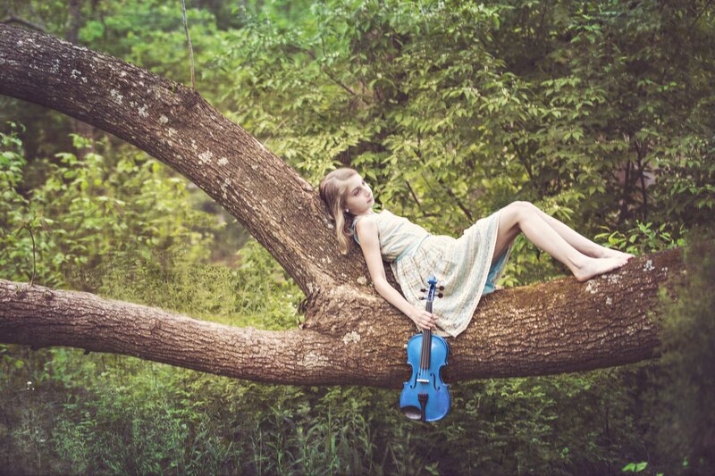Girl Lying on Tree Branch