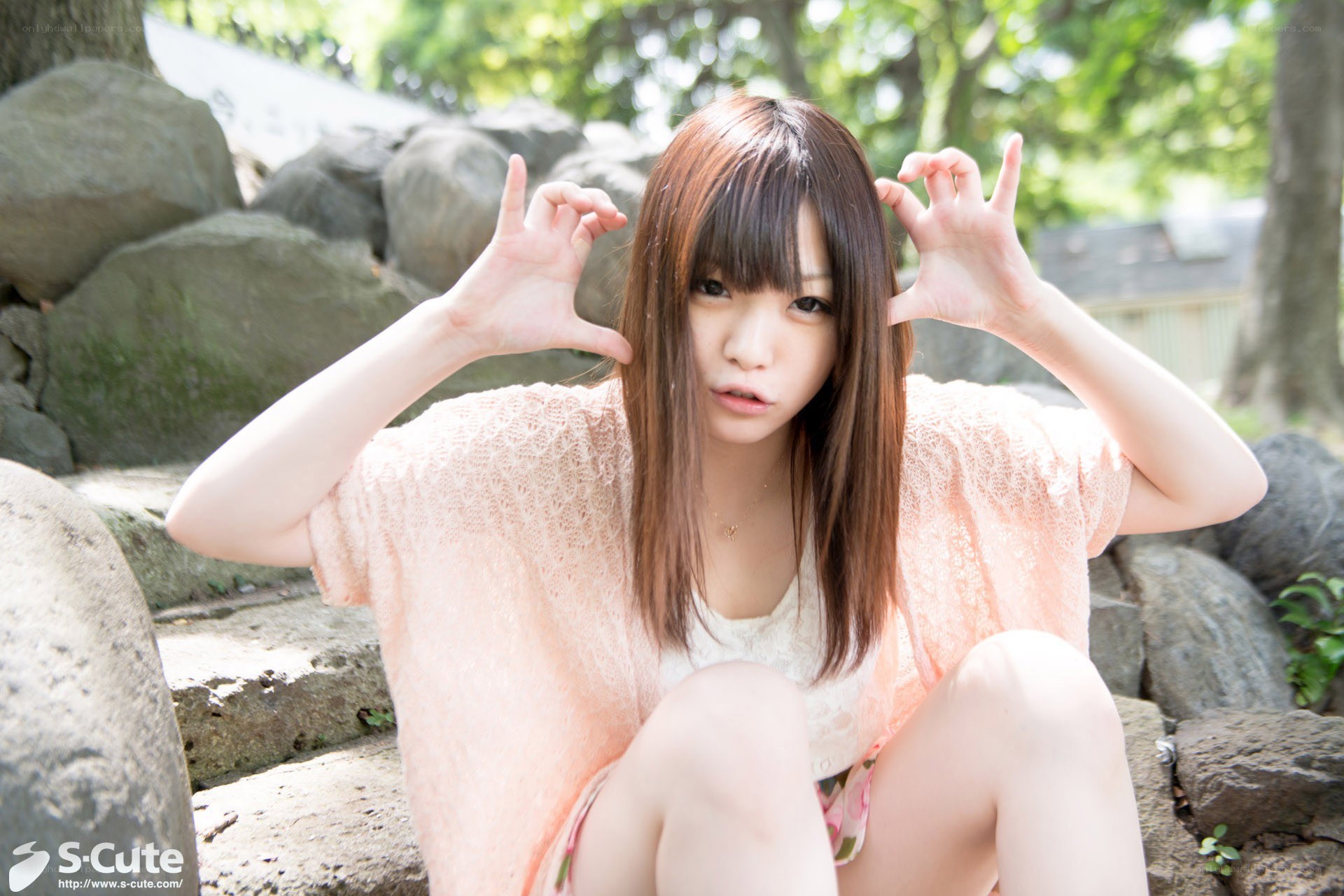 Girl making hand gestures outdoors