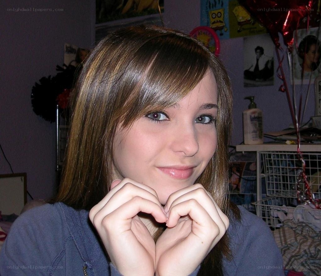 girl making heart with hands