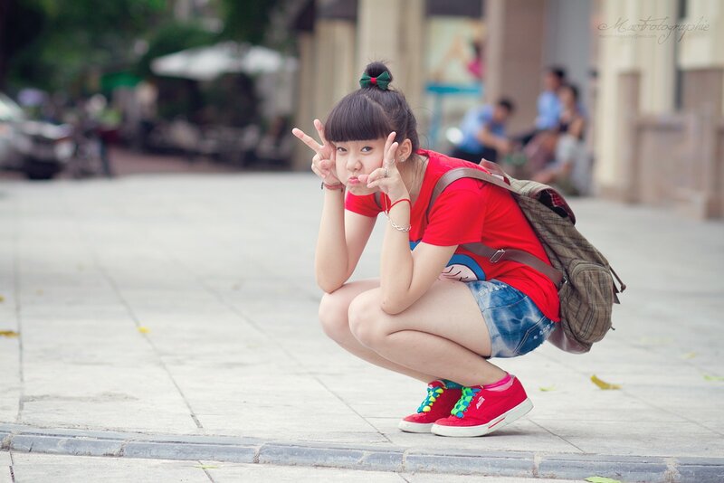 Girl making peace signs outdoors