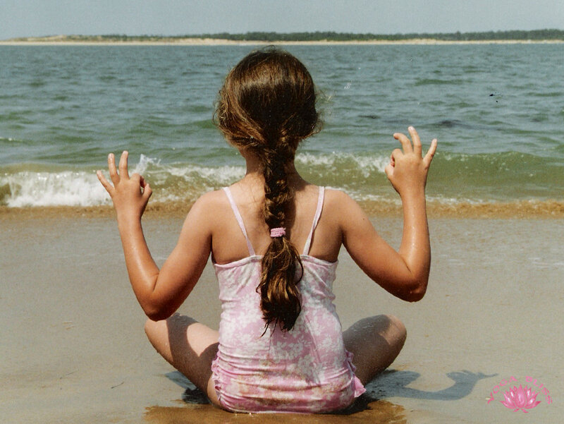 Girl meditating on the beach