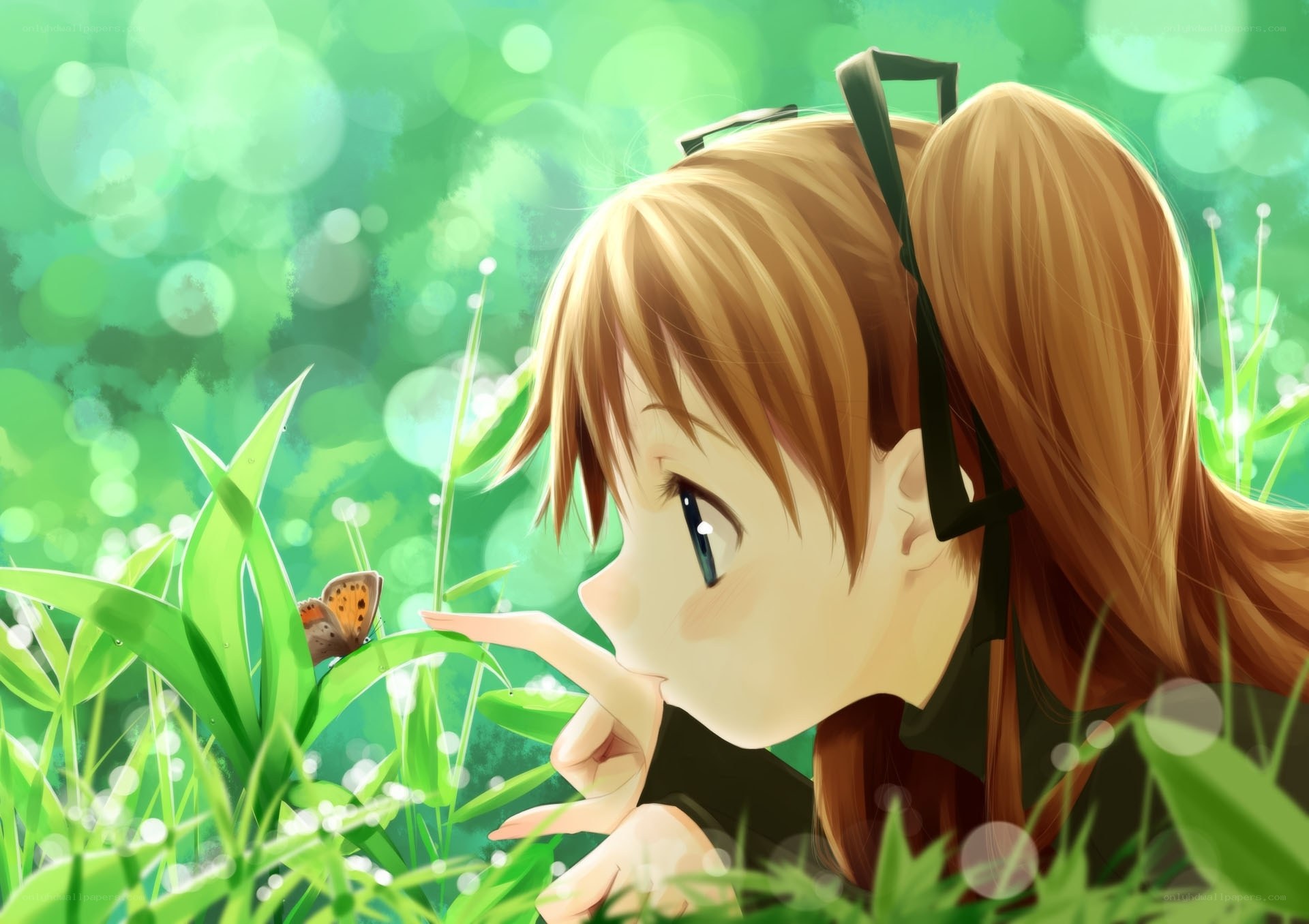 girl observing butterfly in grass