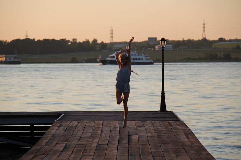 Girl on a dock at sunset