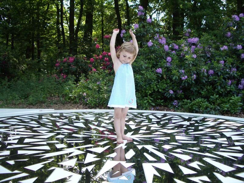Girl on a reflective art installation