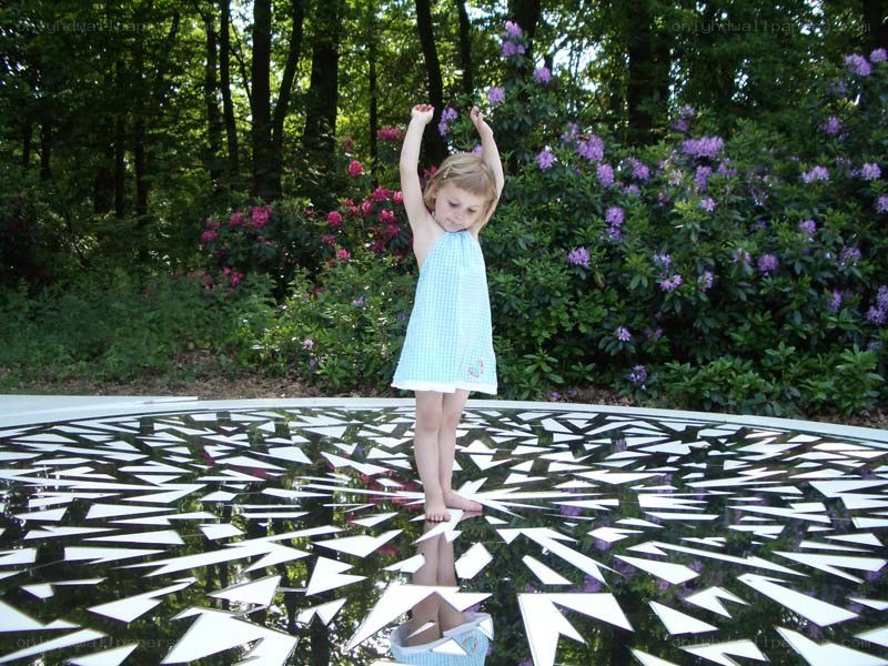 Girl on a reflective art installation