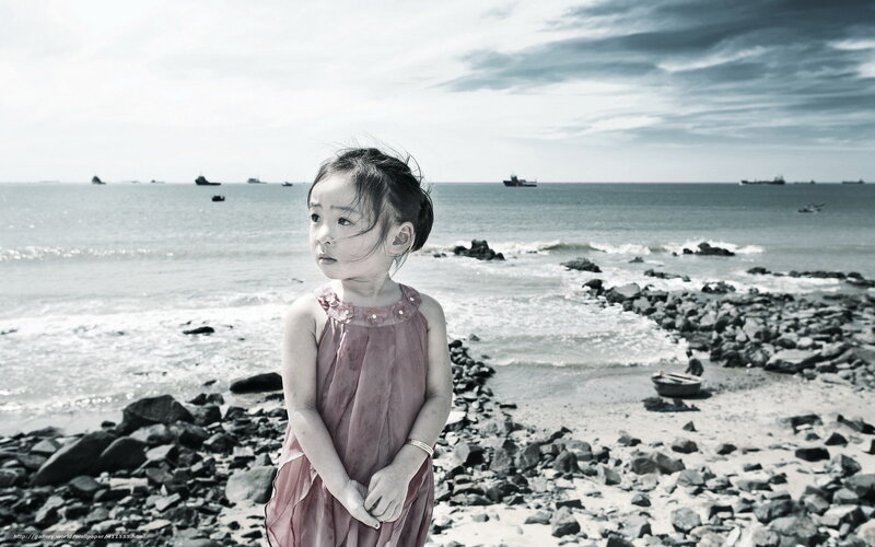 Girl on a rocky beach