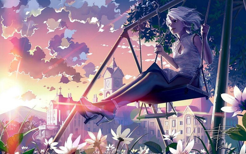 Girl on a swing at sunset