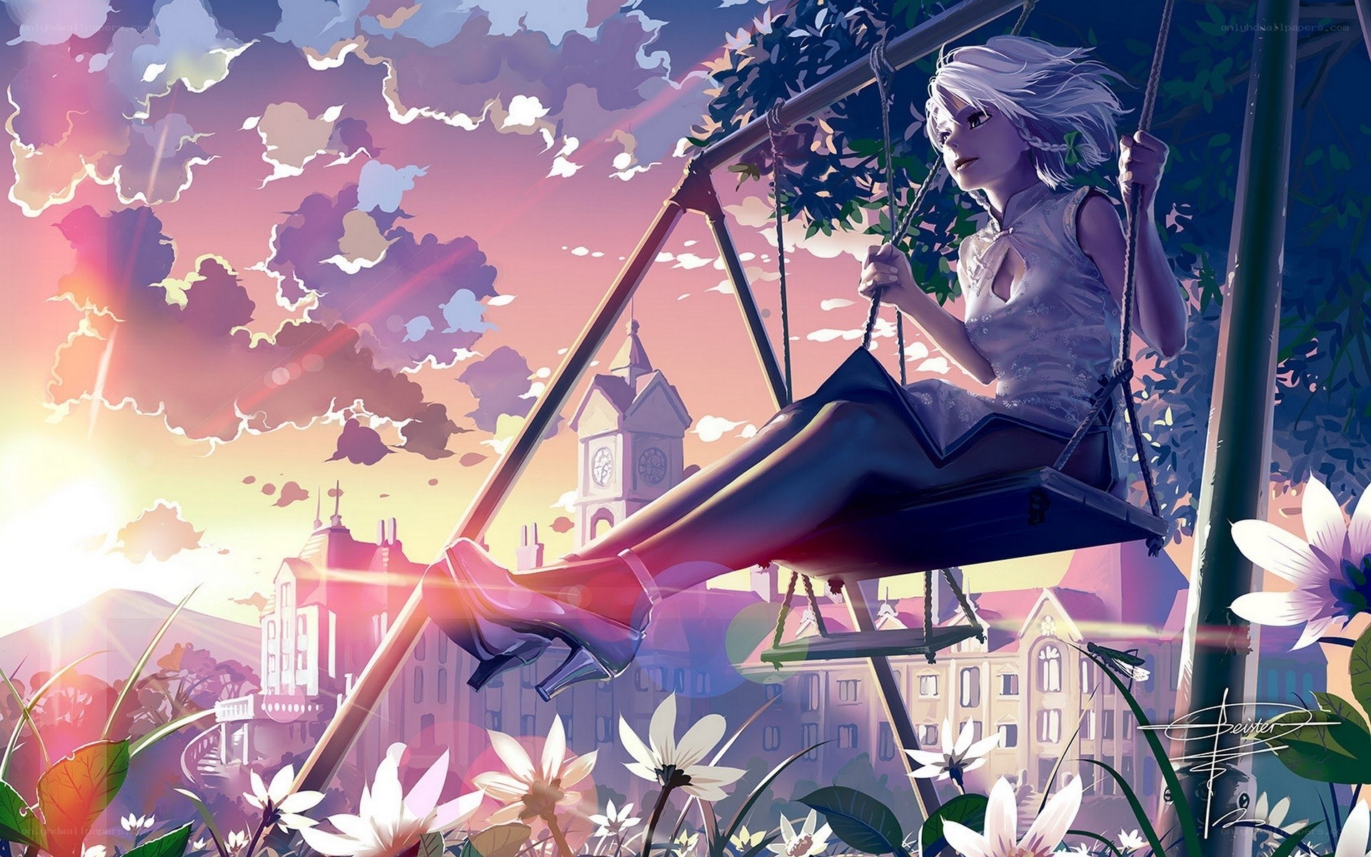 Girl on a swing at sunset