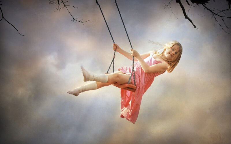 Girl on a swing in the sky