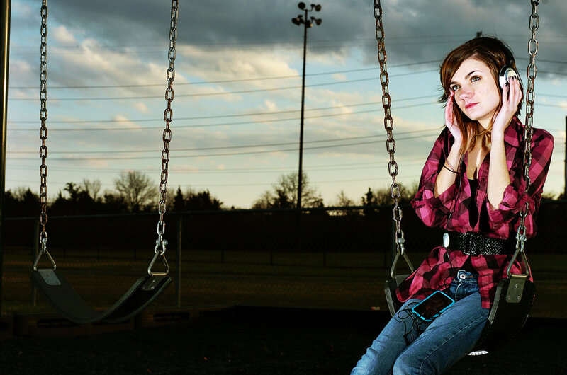 Girl on a swing with headphones
