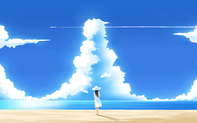 Girl on beach under blue sky