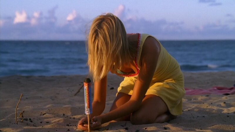 girl on beach with firework
