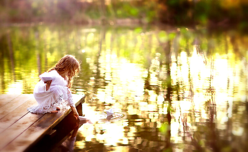 Girl on Dock with Paper Boat