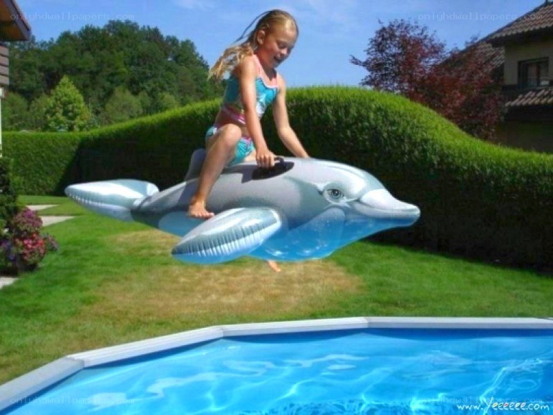 Girl on inflatable dolphin
