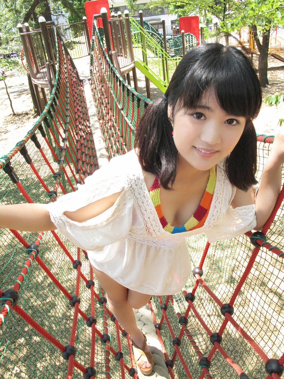 Girl on playground rope bridge