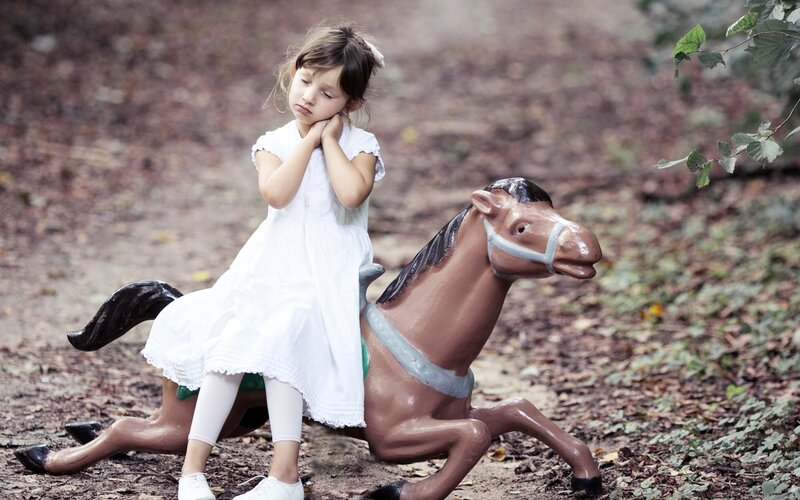 Girl on Toy Horse