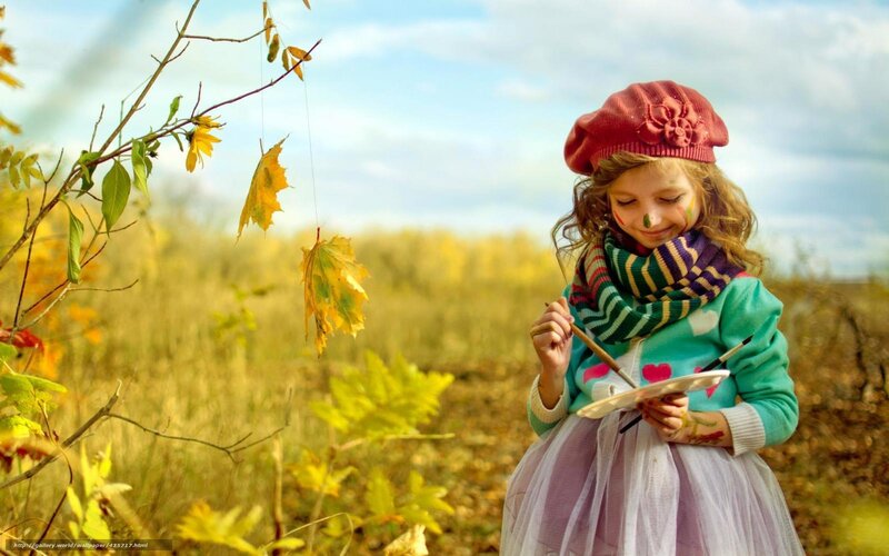 Girl painting in autumn field