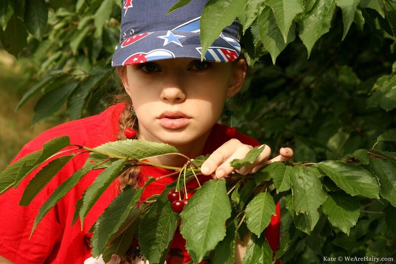 girl picking cherries outdoors