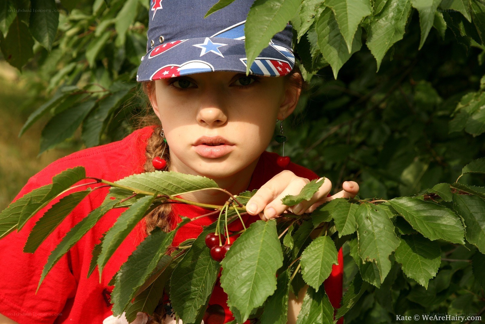 girl picking cherries outdoors