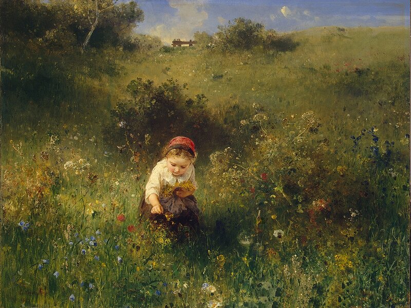 Girl picking wildflowers in a field