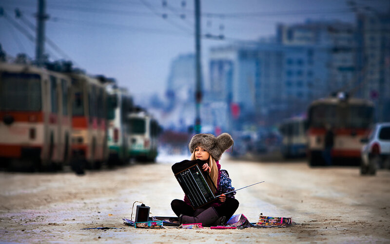 Girl playing accordion on street