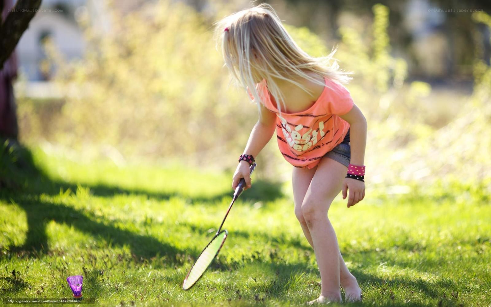 girl playing badminton outdoors