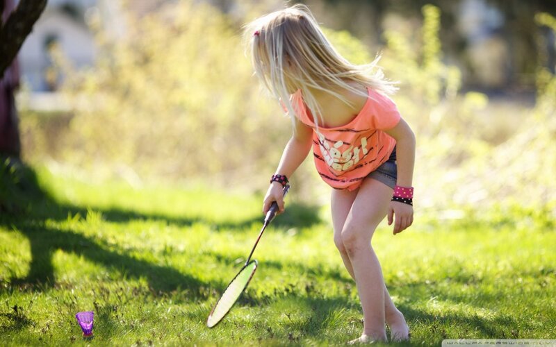 girl playing badminton outdoors