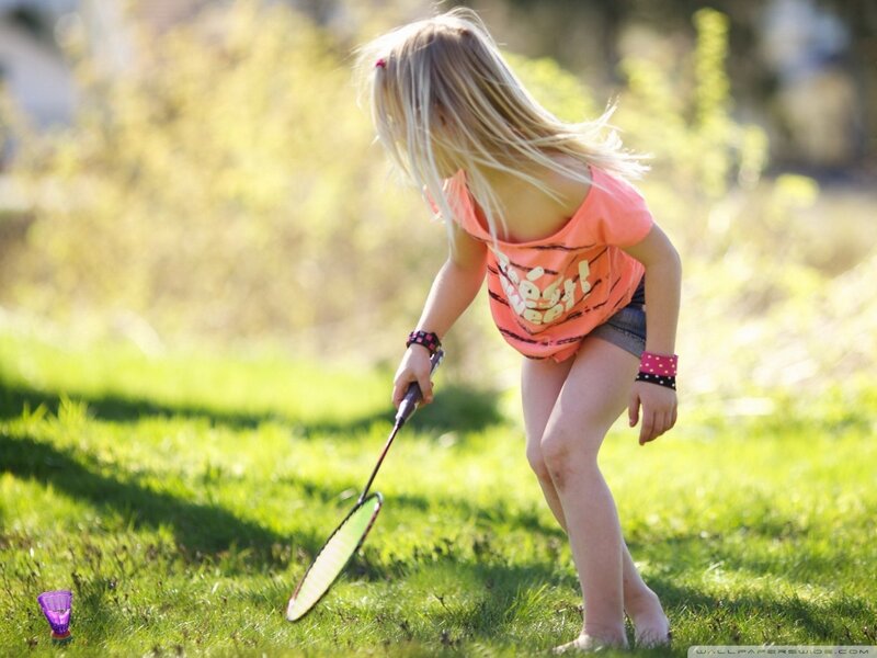 girl playing badminton outdoors