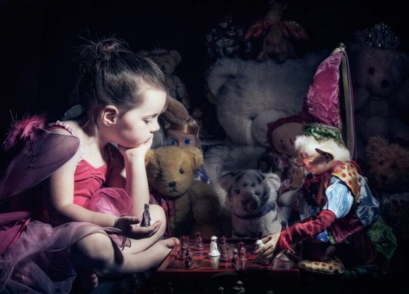 Girl Playing Chess with Toys