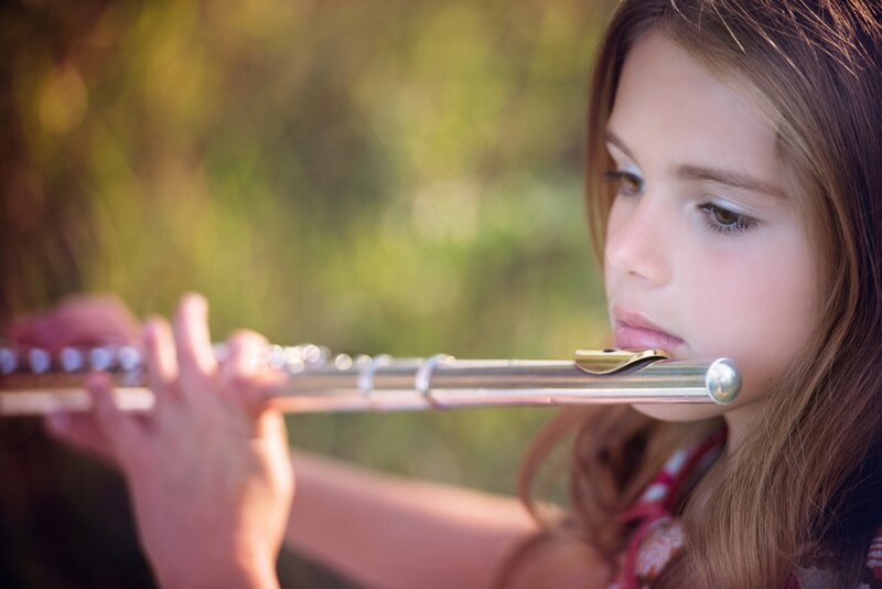 Girl Playing Flute — Brown, Serene