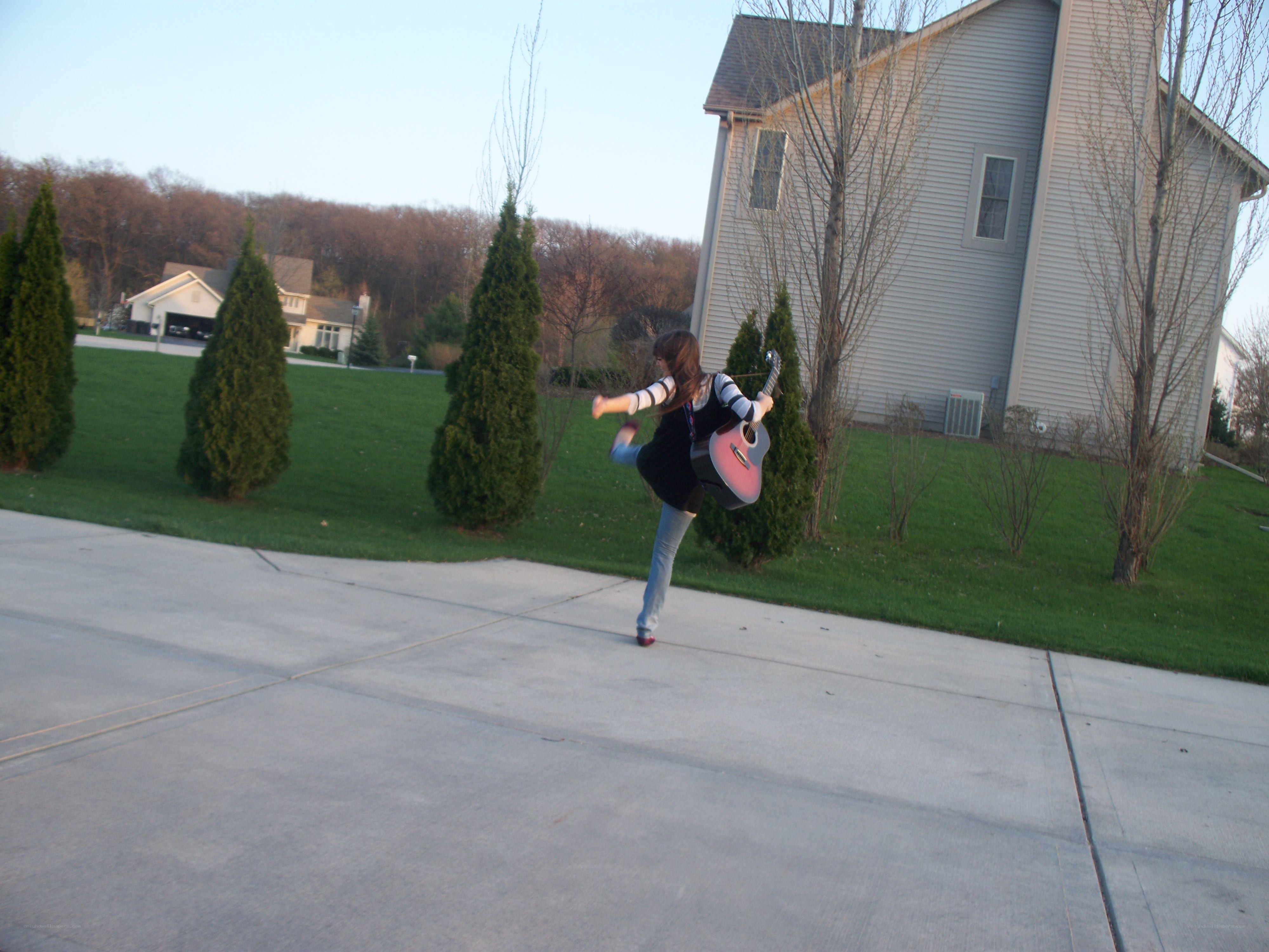 Girl playing guitar outside