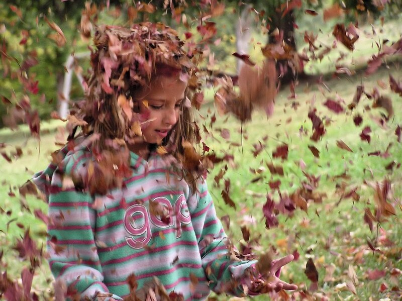 Girl Playing in Leaves