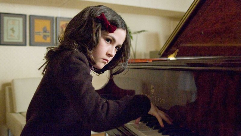 girl playing piano at home