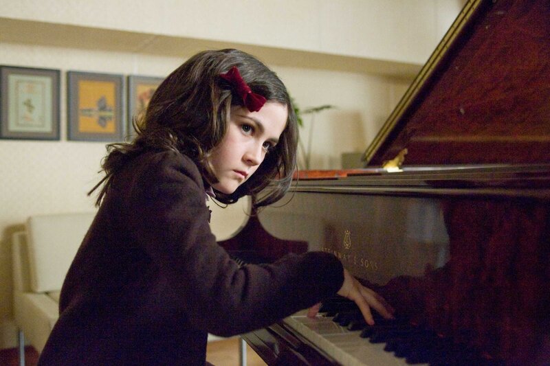 girl playing piano at home