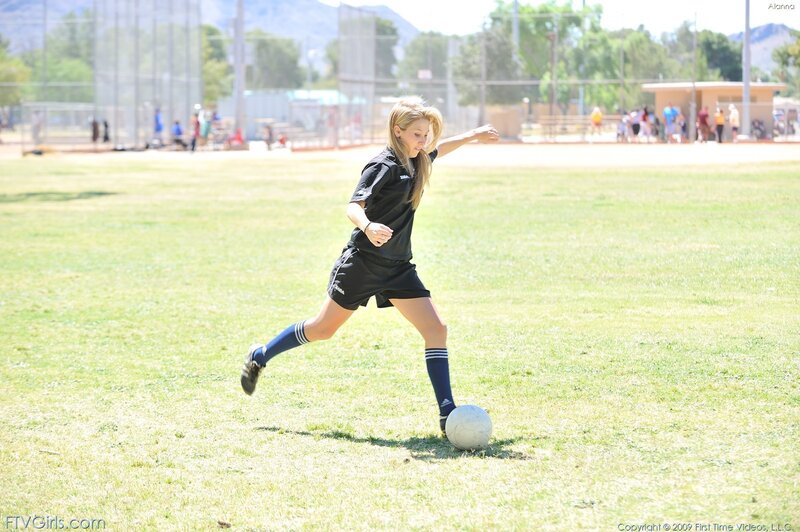 girl playing soccer on field