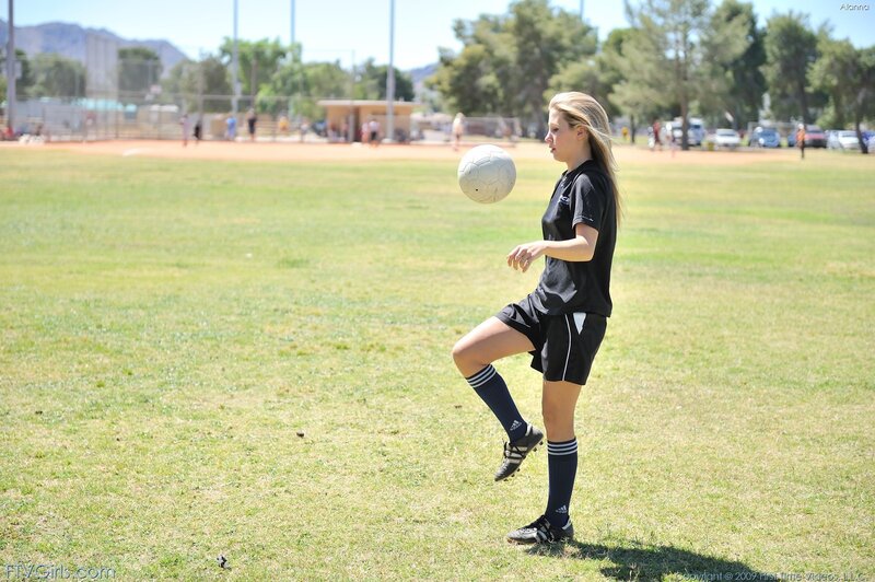 girl playing soccer on field