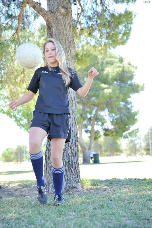 girl playing soccer outdoors