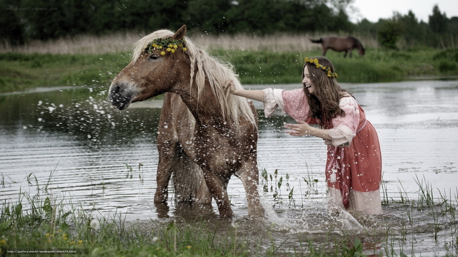Girl playing with horse in water