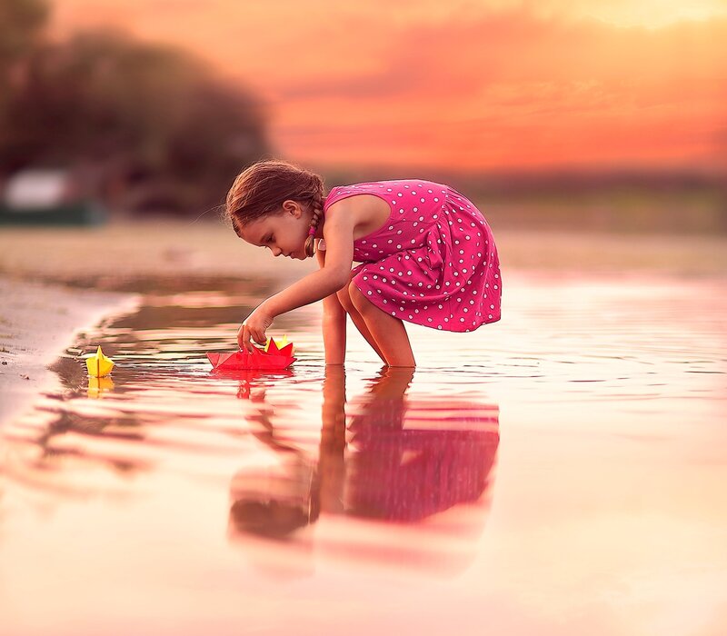 Girl Playing with Paper Boats